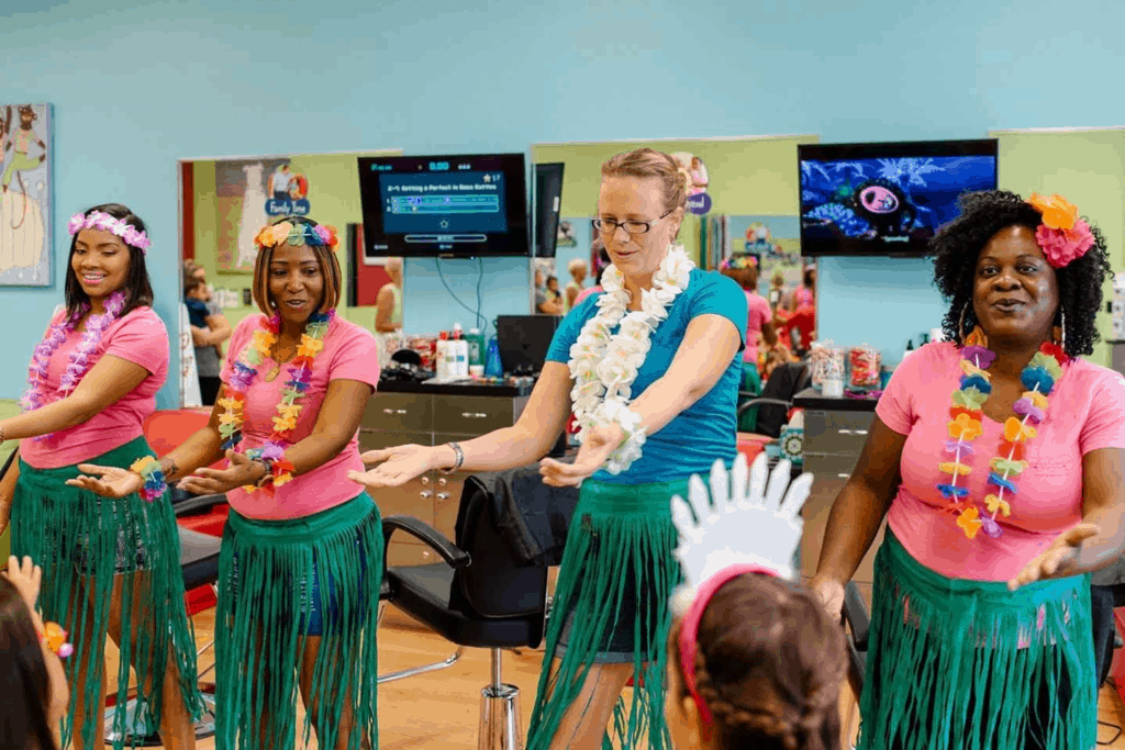 Bobbei Ruswinckel, children's hair salon franchise owner, with stylists dressed in hula dresses