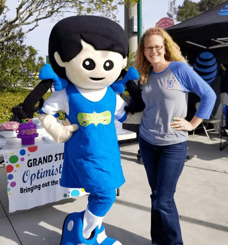Bobbei Ruswinckel, children's hair salon franchise owner, with Pigtails & Crewcuts mascot