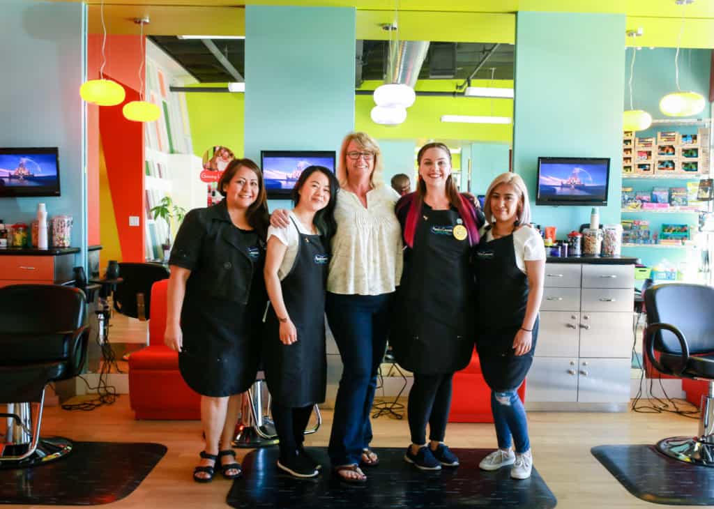 Pigtails & Crewcuts franchise owner Kendra Keating with her staff in her salon